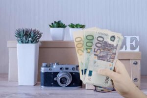 diversi oggetti per la casa e mano con soldi